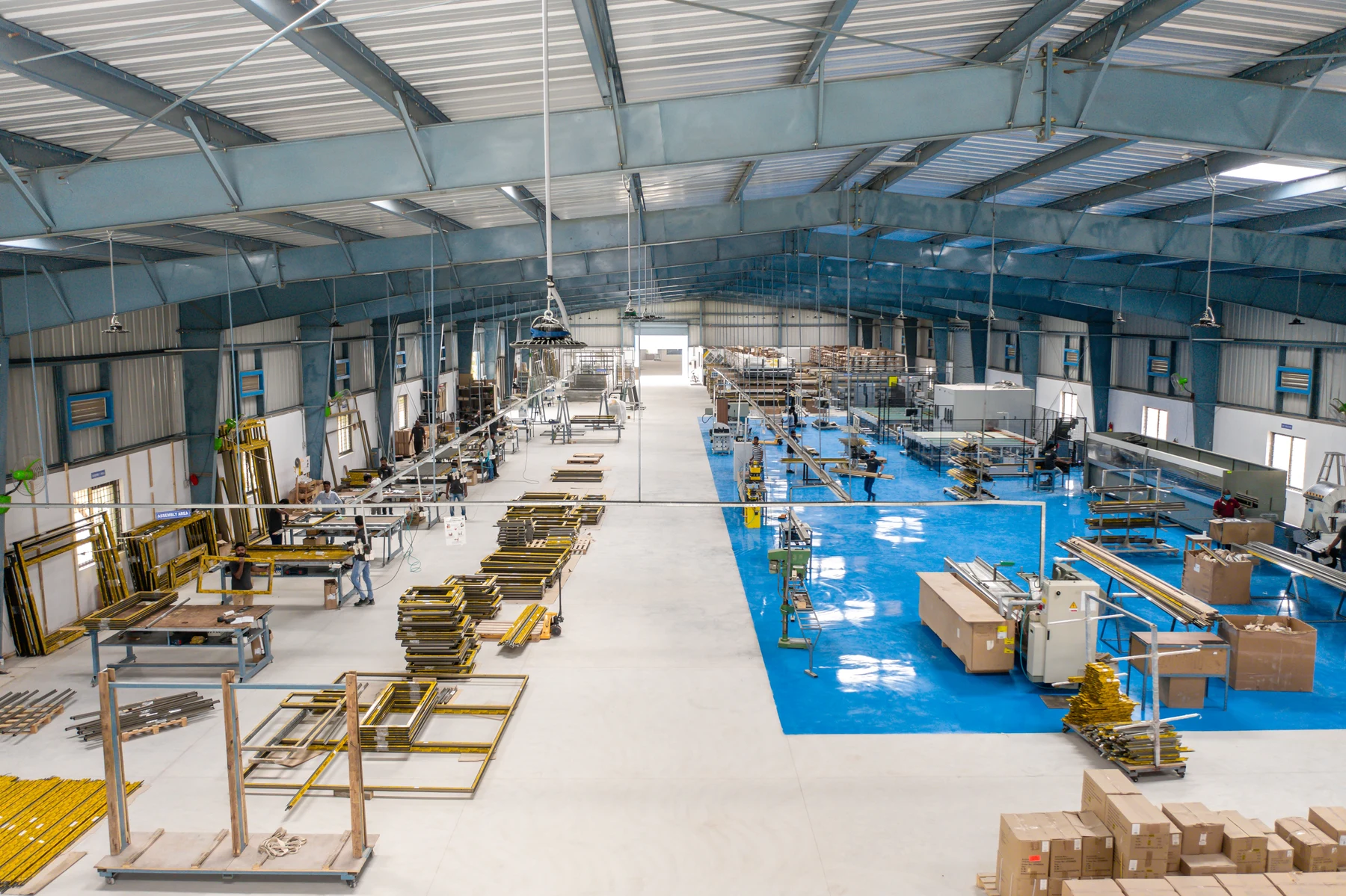 Elevated archive view of the fabrication workshop, with assembly benches, frames and machinery